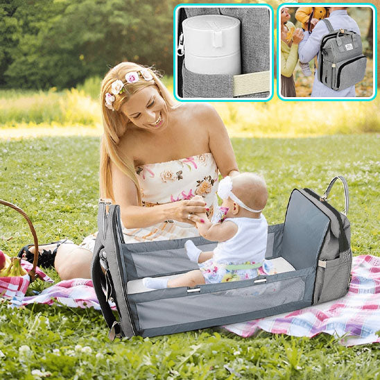 sac a langer lit bebe assis maman heureuse